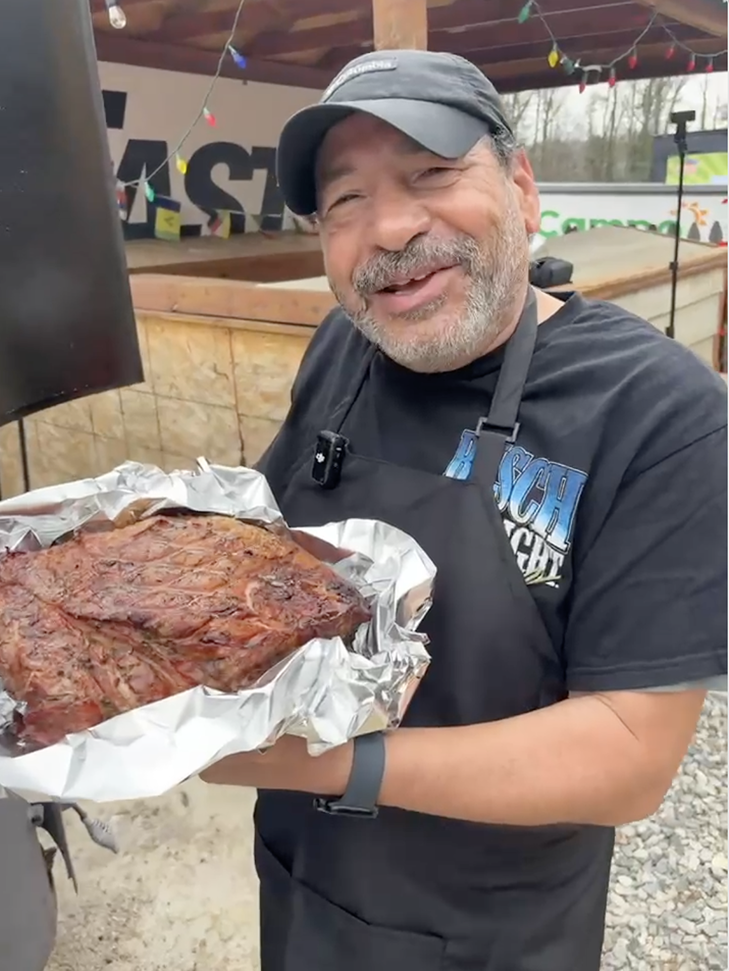 Tony, pitmaster and owner of Uncle Tony's Barbecue, holding freshly smoked meat